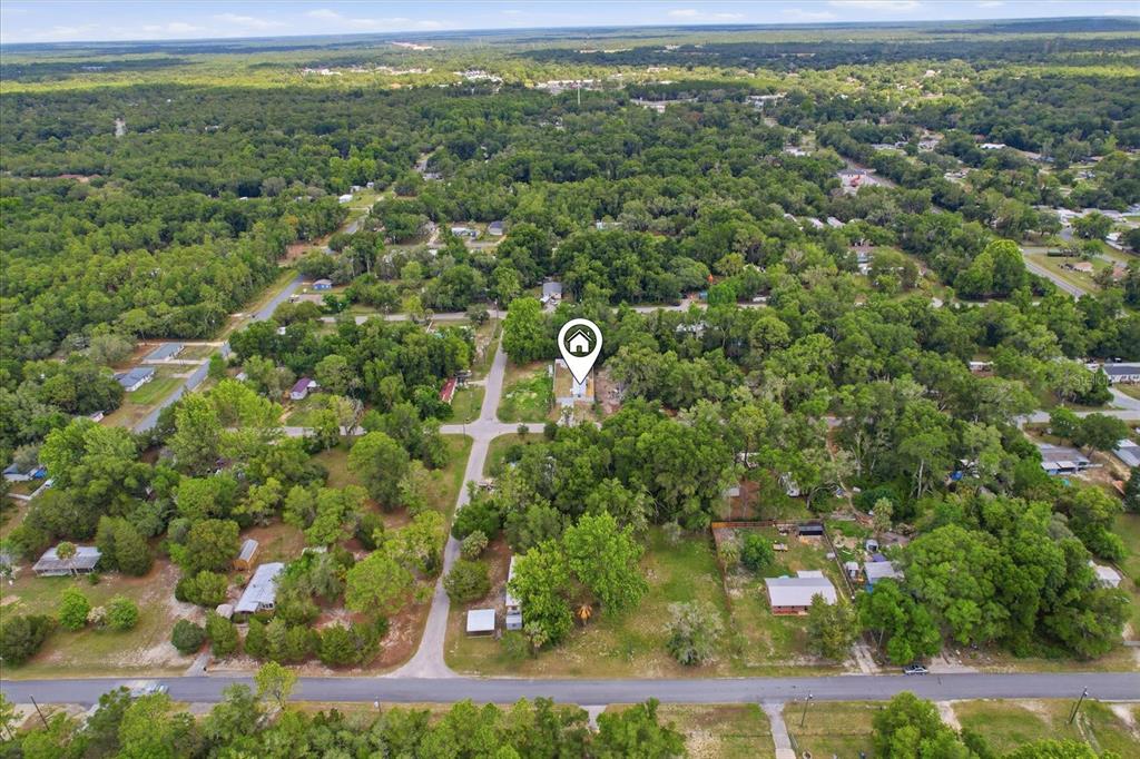 An aerial view shows a residential lot marked with a location pin amidst wooded surroundings — 6403 W TANGERINE LANE, CRYSTAL RIVER, FL