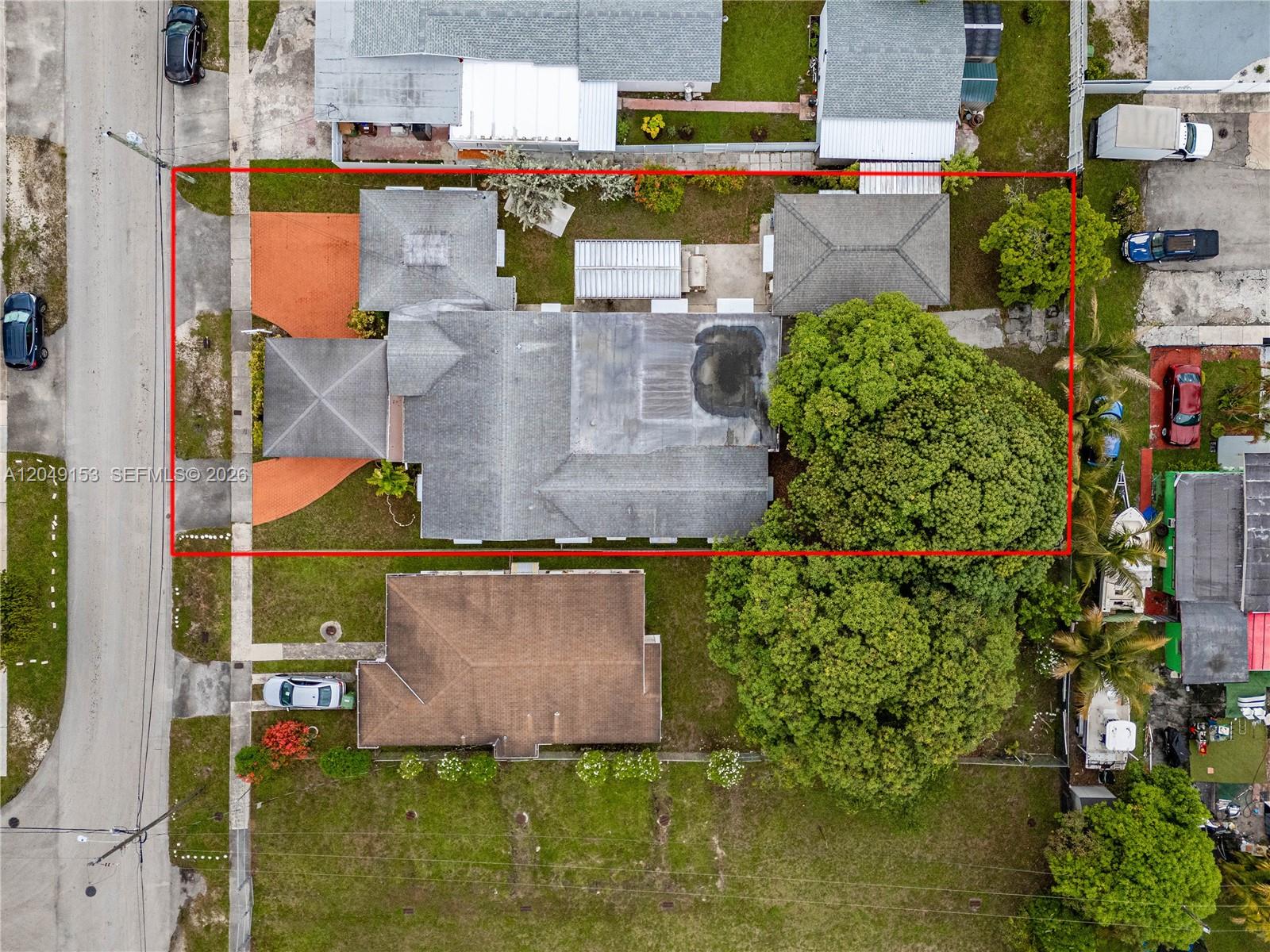 An aerial view shows a residential property with a large tree and a flat roof — 292 W 39th Pl, Hialeah FL 33012, HIALEAH, FL