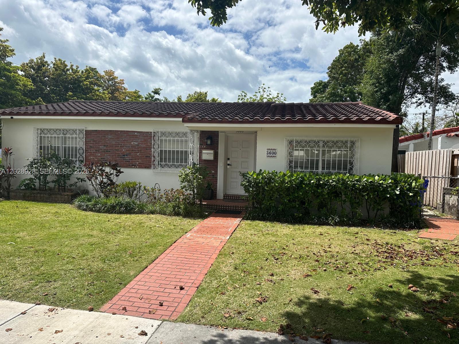 A single-story house with a red tile roof, brick accents, and a brick walkway — 3600 SW 26th St, Miami FL 33133, MIAMI, FL