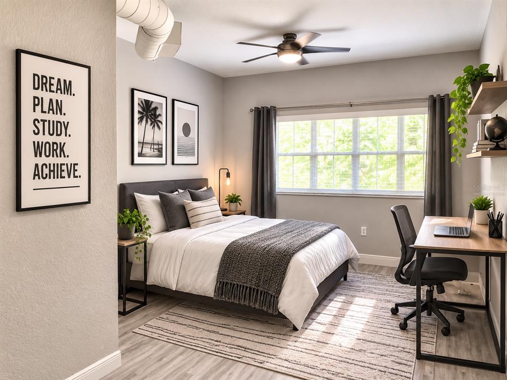 A bedroom features a bed, a desk with a chair, and wall art — 520 S ARMENIA AVENUE UNIT 1235, TAMPA, FL
