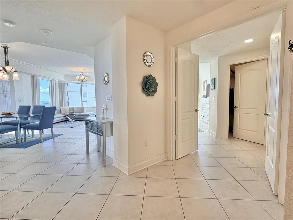 A tiled entryway leads to a dining area and living room with floor-to-ceiling windows — 1200 GULF BOULEVARD UNIT 1001, CLEARWATER, FL