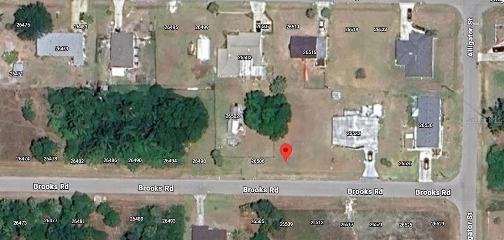 This is an aerial map showing a vacant lot with a red location pin — 26510 BROOKS ROAD, PUNTA GORDA, FL