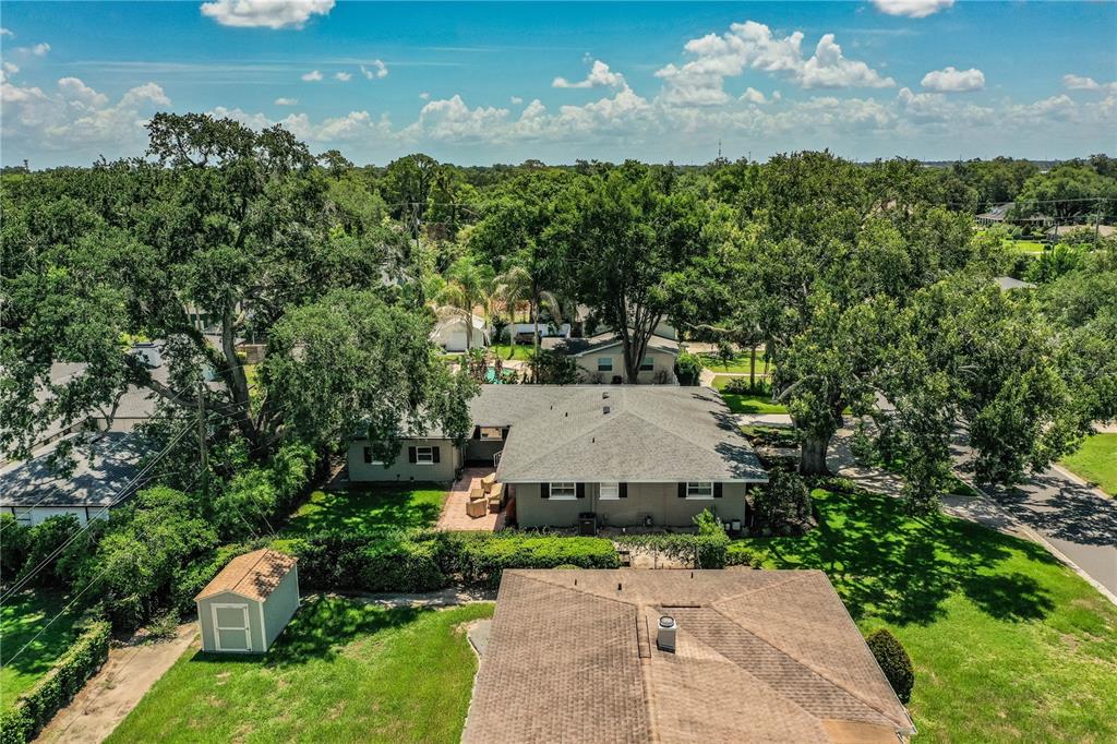 An aerial view shows a gray house with a shingled roof and a small shed — 1522 DEL CREST PLACE, LAKELAND, FL