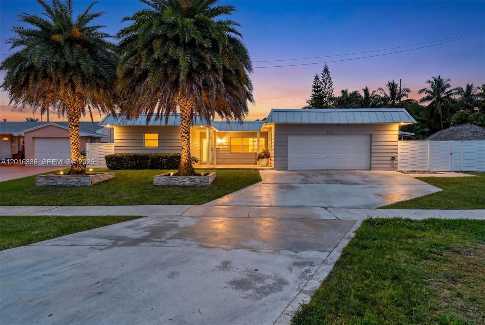 A single-story house with a white garage, two palm trees, and a concrete driveway — 2918 Cleveland St, Hollywood FL 33020, HOLLYWOOD, FL