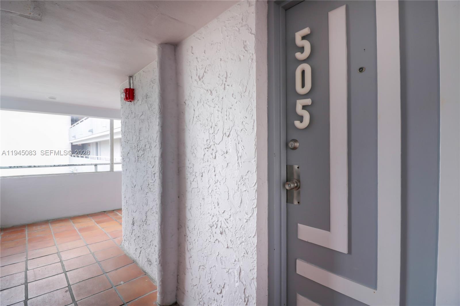 An aerial view shows a multi-story apartment complex situated along a canal with docked boats — 1650 NE 115th St # 505, Miami FL 33181, MIAMI, FL