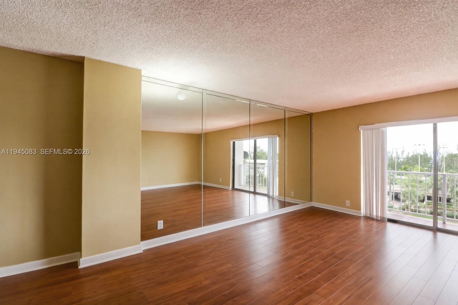 A gray door labeled 505 sits next to a textured white wall on a tiled balcony — 1650 NE 115th St # 505, Miami FL 33181, MIAMI, FL