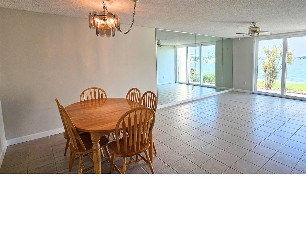 An aerial view of a coastal residential area with buildings, a waterway, and a sunset sky — 7560 BAY ISLAND DRIVE S UNIT 149, SOUTH PASADENA, FL
