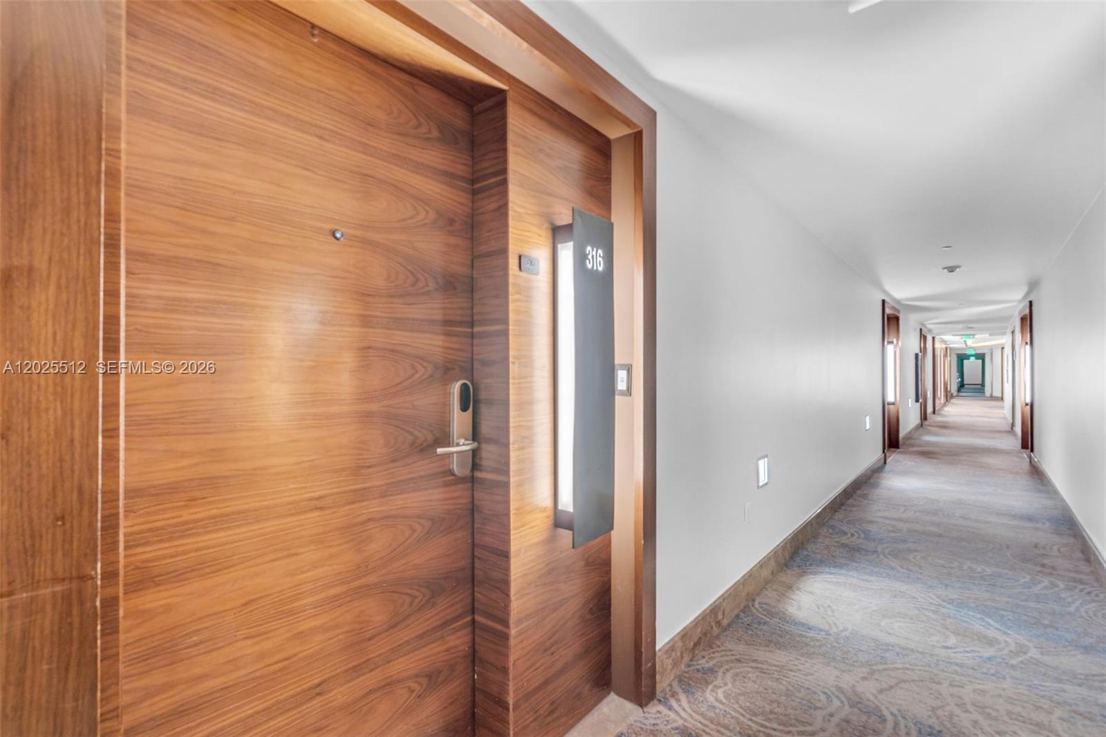A wooden hotel room door labeled 316 is situated along a long, carpeted hallway — 6801 Collins Ave, Miami Beach FL 33141, MIAMI BEACH, FL