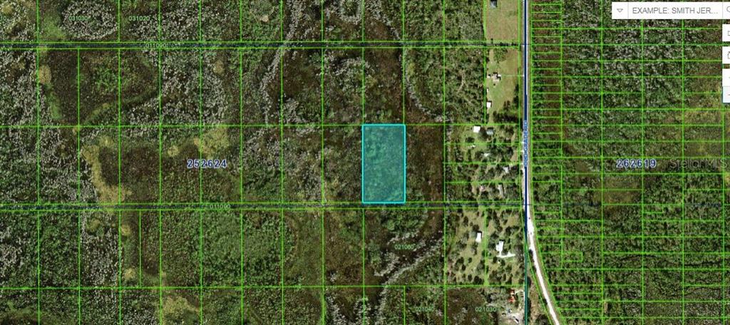 This is an aerial map showing a rectangular parcel of land highlighted in light blue — OLD GRADE RD, POLK CITY, FL