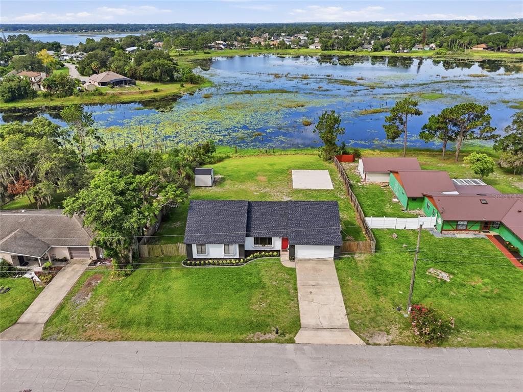 An aerial view shows a single-story house with a dark roof and a concrete driveway — 2643 SALTERS COURT, DELTONA, FL