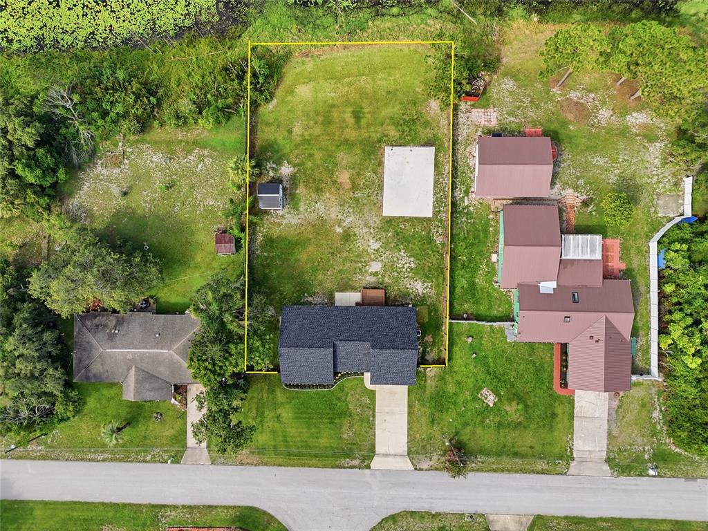 An aerial view shows a residential property lot outlined in yellow with a house and shed — 2643 SALTERS COURT, DELTONA, FL
