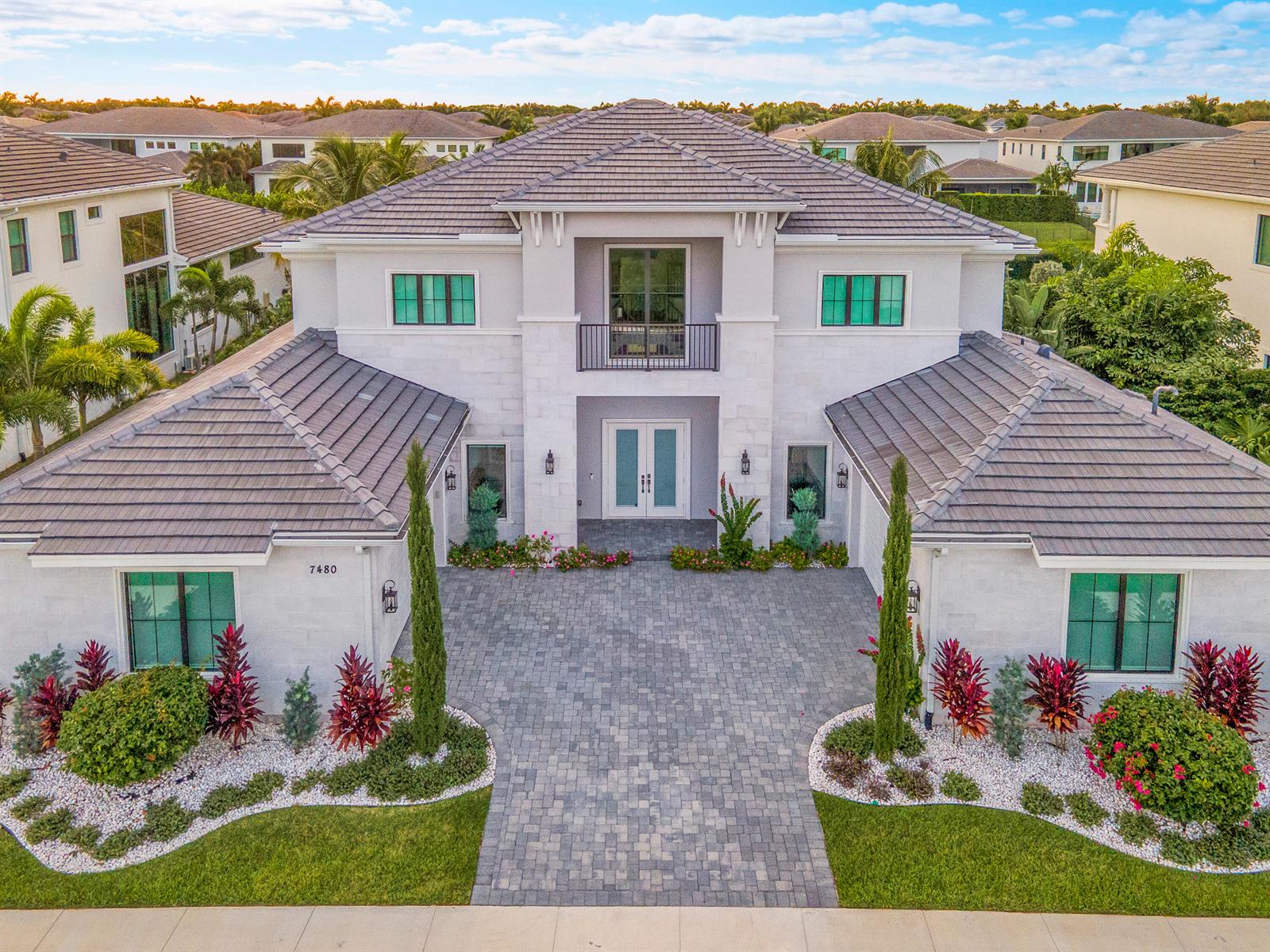 A two-story house with a tiled roof, stone facade, and a paved driveway — 7480 NW 26th Way, Boca Raton FL 33496, BOCA RATON, FL