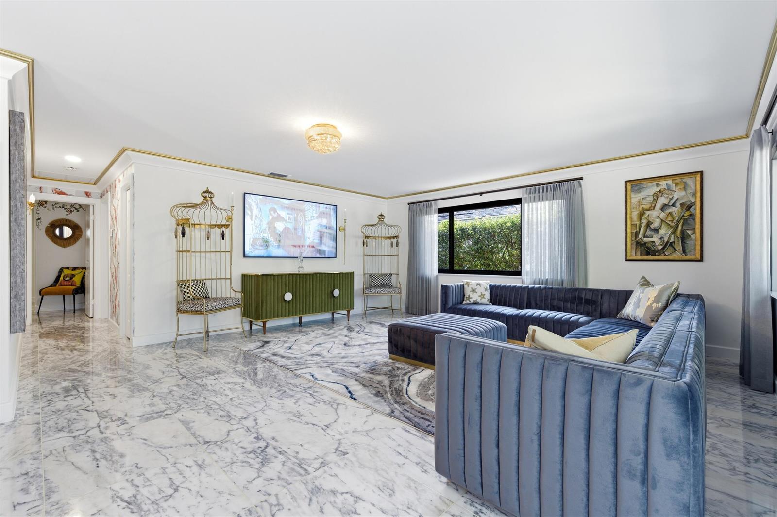 A living room features a blue velvet sectional, marble floors, and two gold birdcage chairs — 702 S Atlantic Drive, Lantana FL 33462, LANTANA, FL