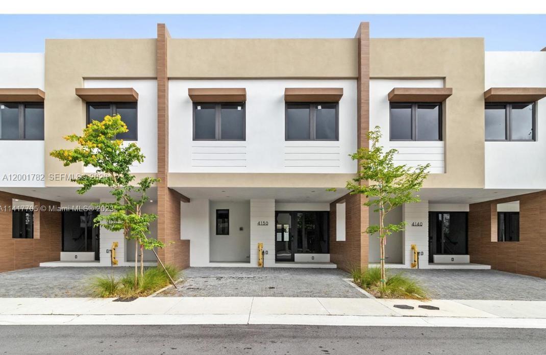 A bright interior features a carpeted staircase with a black railing beside a tiled floor — 4130 N Oak Pl # 4130, Dania Beach FL 33314, DANIA BEACH, FL