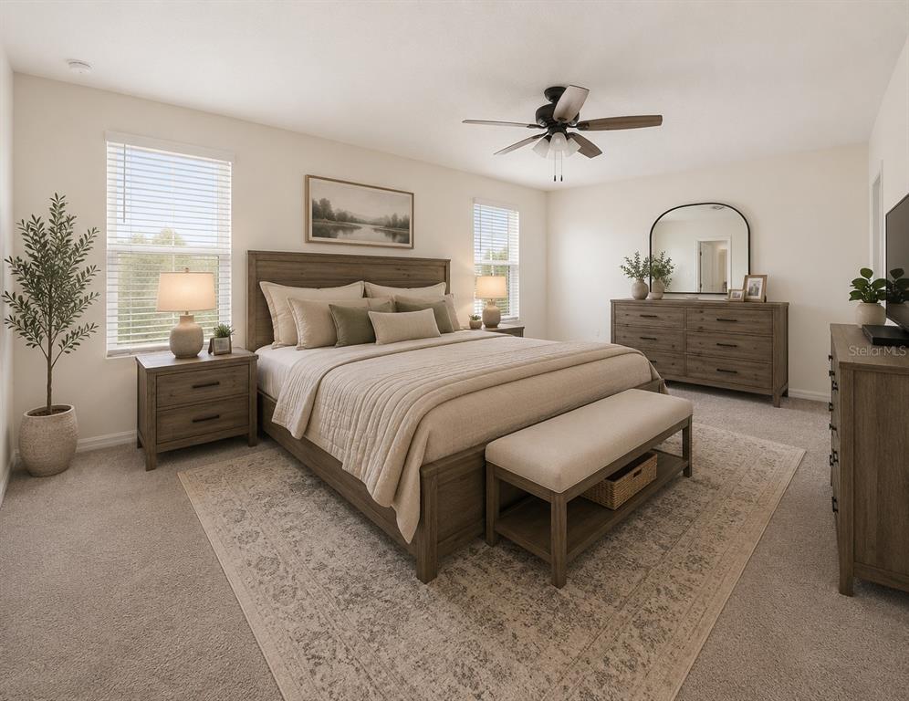 A bedroom features a wooden bed frame, matching dresser, nightstands, and a neutral-toned area rug — 24595 NW 11TH PLACE, NEWBERRY, FL