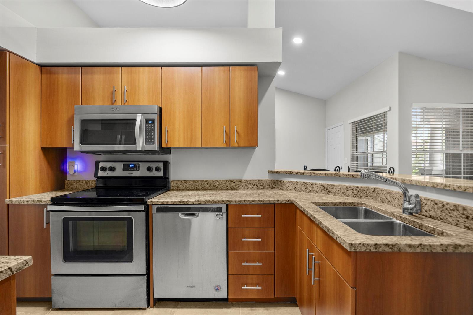 A kitchen features wood cabinets, granite countertops, and stainless steel appliances — 1000 Crystal Way # L, FL 33444, FL