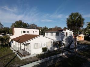 An aerial view shows a white multi-story residential building with a brown shingled roof — 1301 26TH AVENUE S, ST PETERSBURG, FL