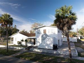 A two-story white house with a flat roof and palm trees in the front yard — 1301 26TH AVENUE S, ST PETERSBURG, FL