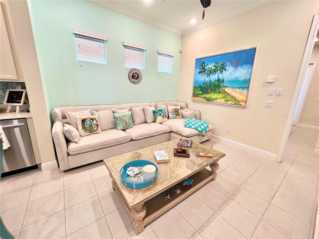 A hot tub sits on a paved patio surrounded by outdoor furniture and palm trees — 8036 SURF STREET, KISSIMMEE, FL