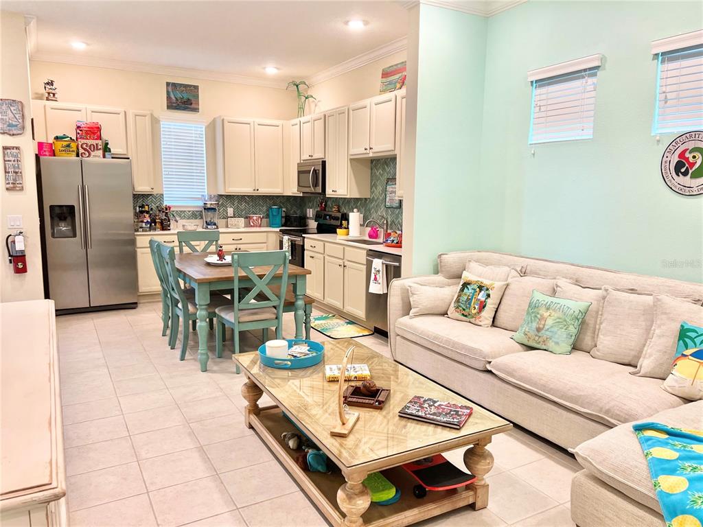 A light blue two-story house features a patio, hot tub, and palm trees — 8036 SURF STREET, KISSIMMEE, FL