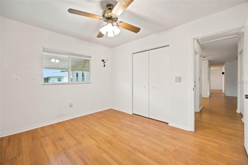 A galley kitchen features white cabinets, granite countertops, stainless steel appliances, and light tile flooring — 6483 SW 110TH STREET, OCALA, FL