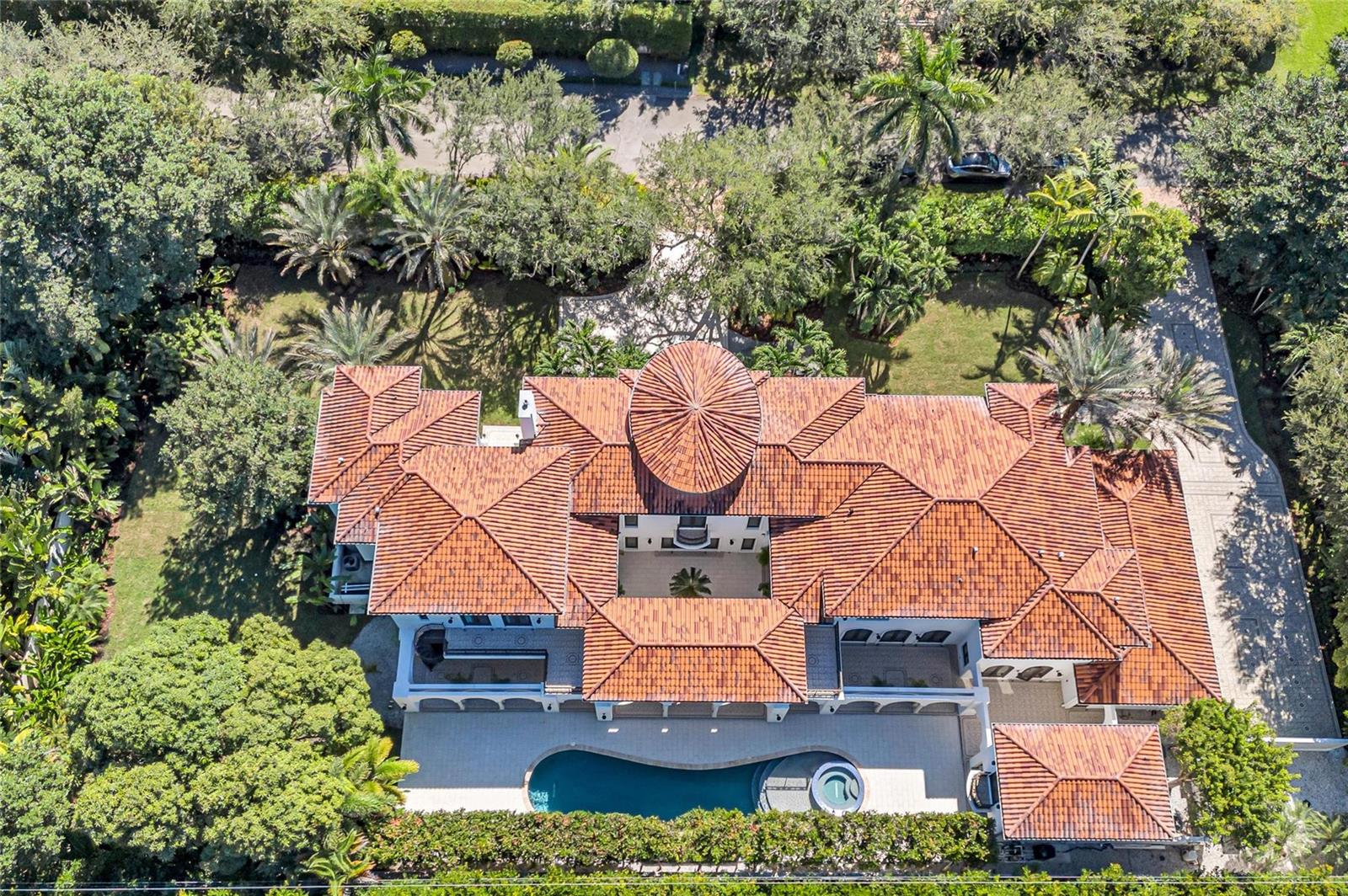 An aerial view shows a large Mediterranean-style house with a red tile roof and pool — 4955 SW 83rd Street, Miami FL 33143, MIAMI, FL