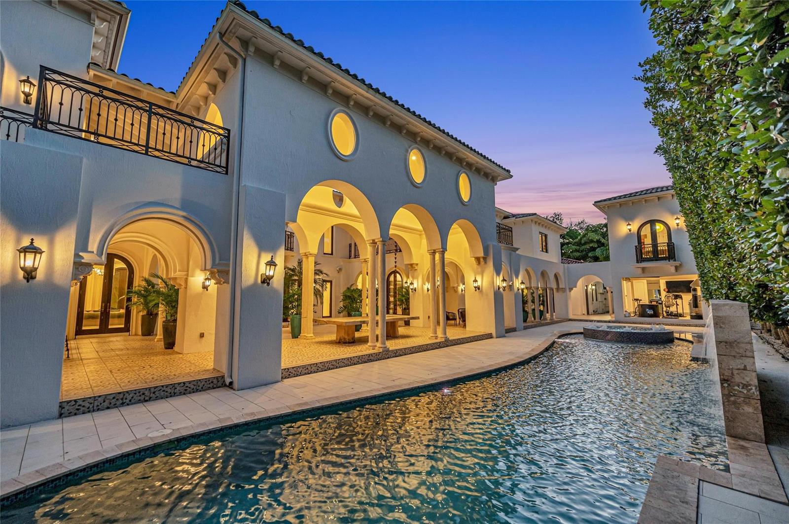 A Mediterranean-style home features a covered arched patio, a swimming pool, and upper-level balconies — 4955 SW 83rd Street, Miami FL 33143, MIAMI, FL