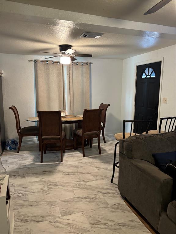 A dining area with a table, four chairs, and marble-look tile flooring — 2440 WEBER STREET, LAKELAND, FL