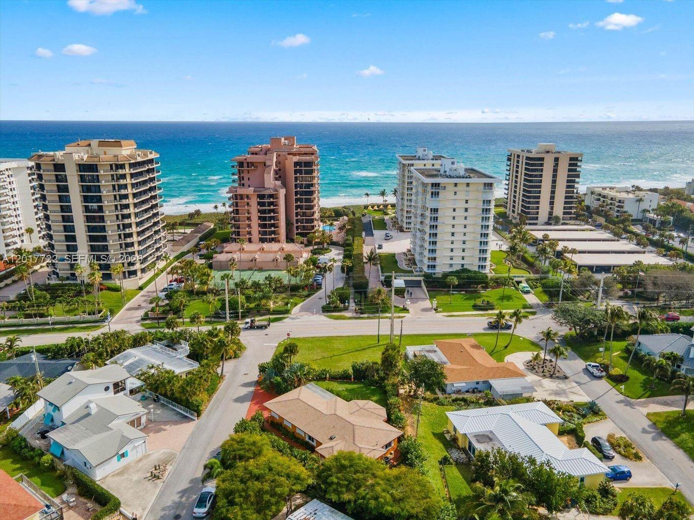 An aerial view shows several high-rise apartment buildings situated along a sandy beach and ocean — xxxx Neptune Rd, Juno Beach FL 33408, JUNO BEACH, FL