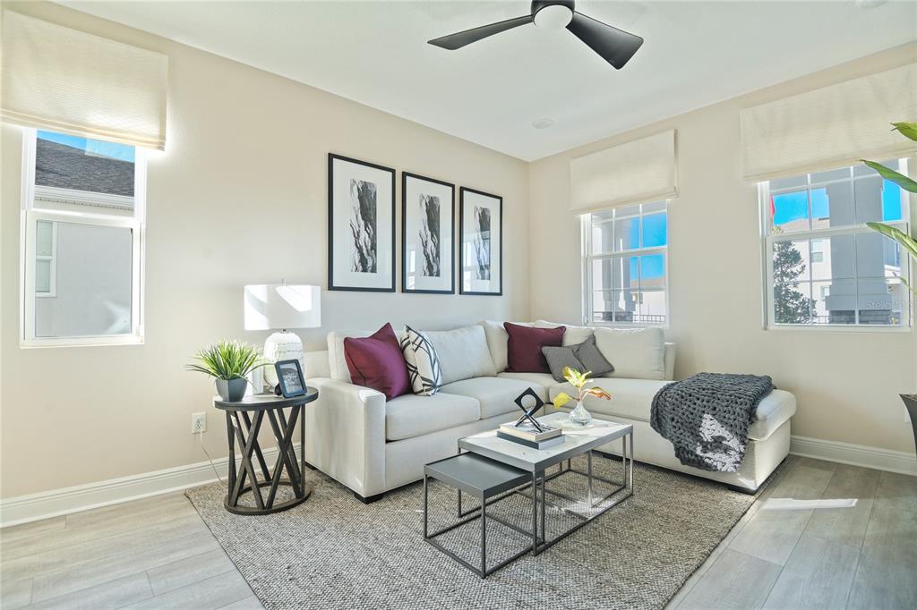 A living room features a white sectional sofa, a nested coffee table, and three framed prints — 5110 KINSLEY DRIVE, WINTER HAVEN, FL