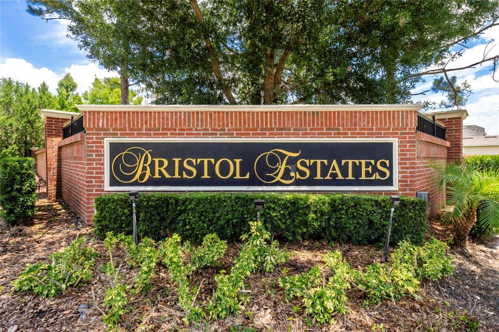 A brick entrance sign for Bristol Estates stands in front of trees and landscaping — 16431 BRISTOL LAKE CIRCLE, ORLANDO, FL