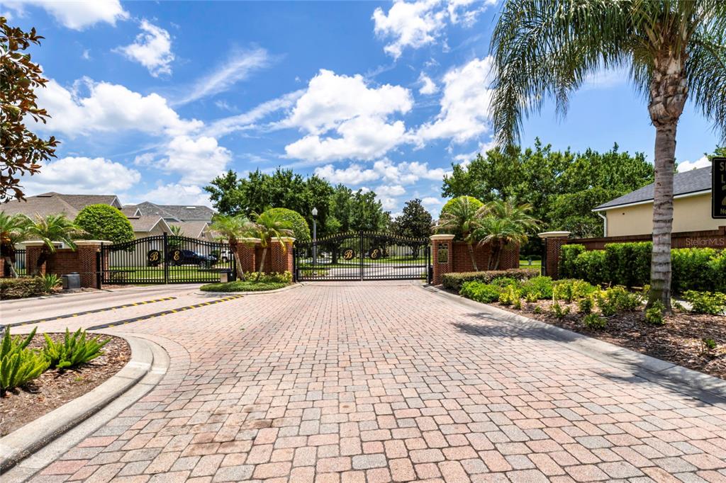 A gated entrance with brick pillars and a paved driveway leads to a residential community — 16431 BRISTOL LAKE CIRCLE, ORLANDO, FL