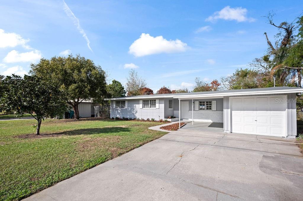 A single-story gray house with a white garage and a concrete driveway — 600 VENTURA AVENUE, ORLANDO, FL