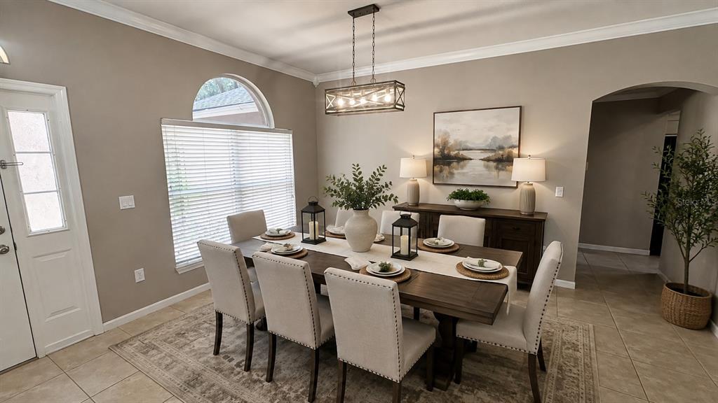 A dining room features a wooden table with six upholstered chairs and a rectangular chandelier — 4613 RIVER OVERLOOK DRIVE, VALRICO, FL