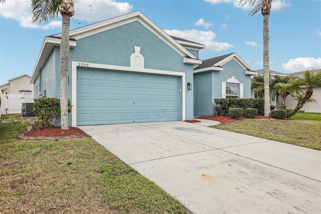 A blue single-story house with a two-car garage and a concrete driveway — 2700 SIERRA VISTA WAY, HOLIDAY, FL