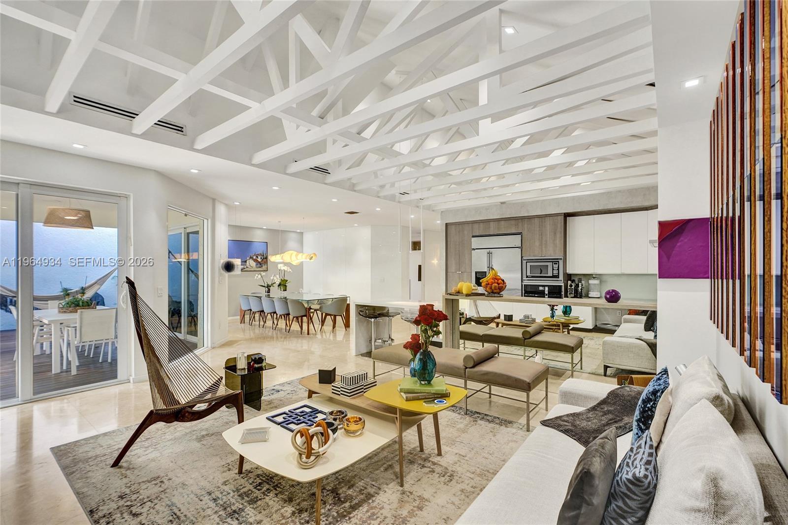 A modern open-concept living and dining area features a white vaulted truss ceiling — 1662 Diplomat Dr, Miami FL 33179, MIAMI, FL