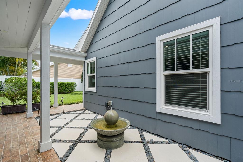 A bright entryway features a white door, hardwood floors, a rug, and a console table — 3233 W PARKLAND BOULEVARD, TAMPA, FL