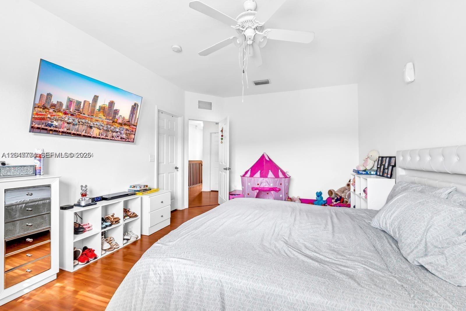 A bedroom features a bed, a television, a ceiling fan, and a children's play tent — 1942 SE 23rd Ter, Homestead FL 33035, HOMESTEAD, FL