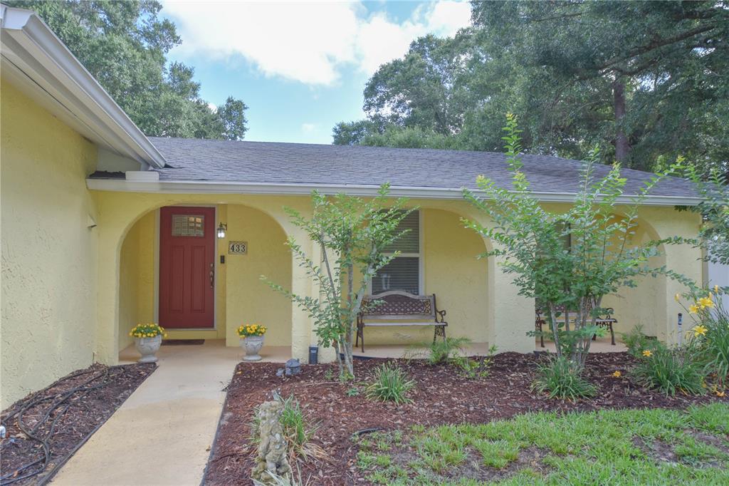 A yellow house with a red front door and a covered arched porch — 433 CENTER STREET, ALTAMONTE SPRINGS, FL
