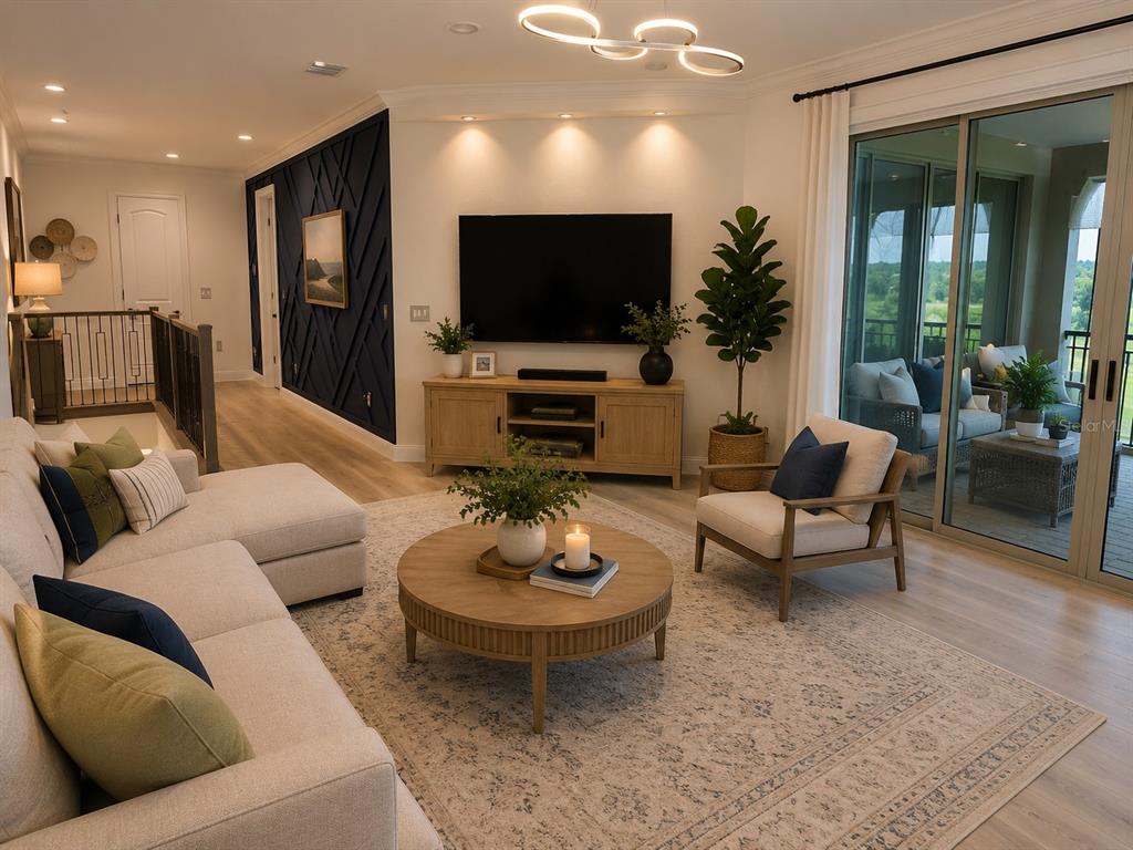 A living room features a sectional sofa, a round coffee table, and a dark accent wall — 13207 AYLESBURY STREET, ORLANDO, FL