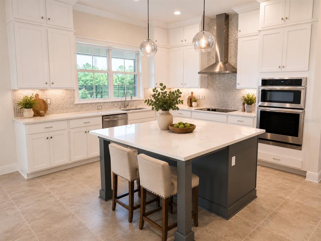 A modern kitchen features white cabinetry, a dark gray island, and stainless steel appliances — 13207 AYLESBURY STREET, ORLANDO, FL
