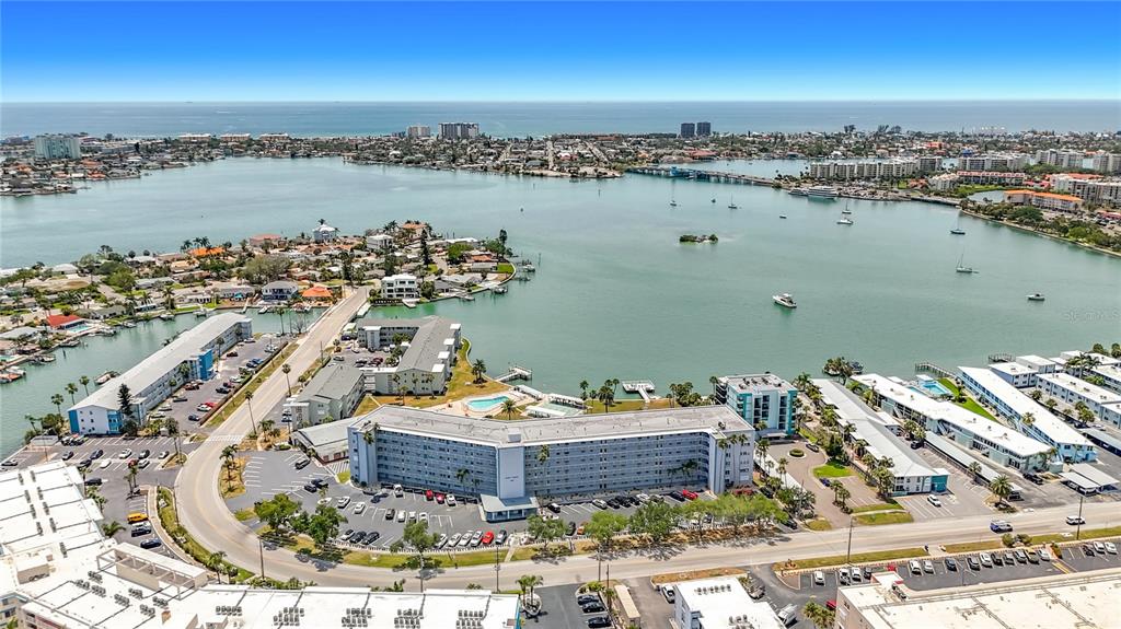 An aerial view shows a large apartment complex situated on a waterfront peninsula — 1868 SHORE DRIVE S UNIT 503, SOUTH PASADENA, FL