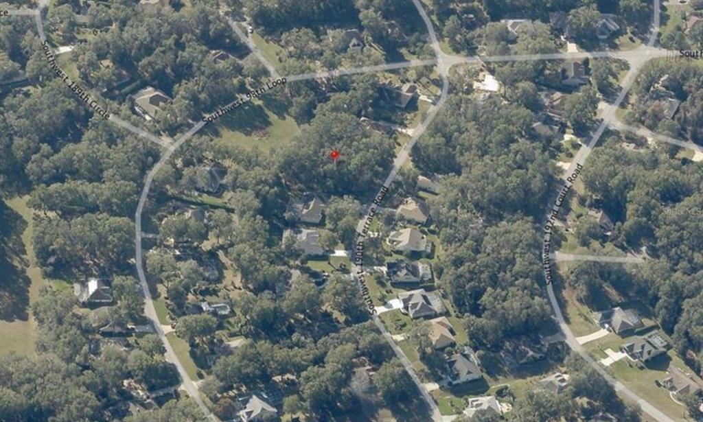 An aerial view shows a wooded residential lot marked with a red pin — SW 190TH TERRACE, DUNNELLON, FL