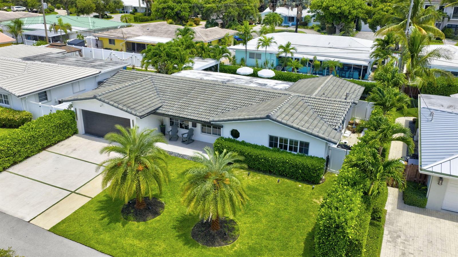An aerial view shows a white house with a gray tile roof and palm trees — 2917 NE 35th Court, Lighthouse Point FL 33064, LIGHTHOUSE POINT, FL