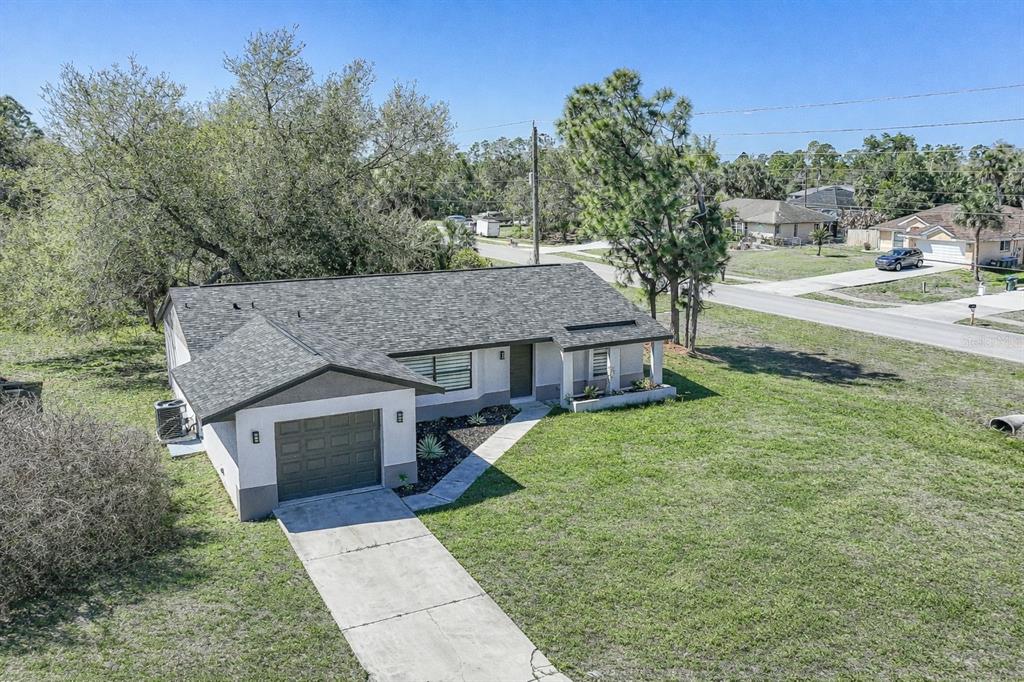An aerial view of a single-story house with a gray roof and attached garage — 5009 JODY AVENUE, NORTH PORT, FL