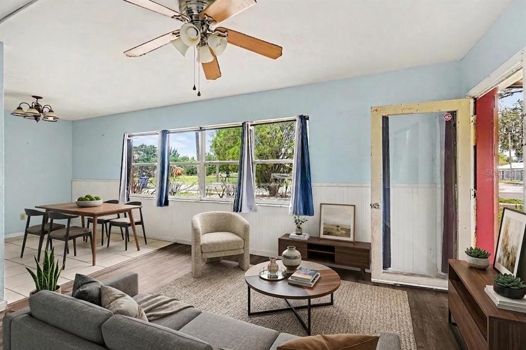 A living and dining area with light blue walls, wood-look flooring, and a ceiling fan — 520 S ORANGE AVENUE, FORT MEADE, FL