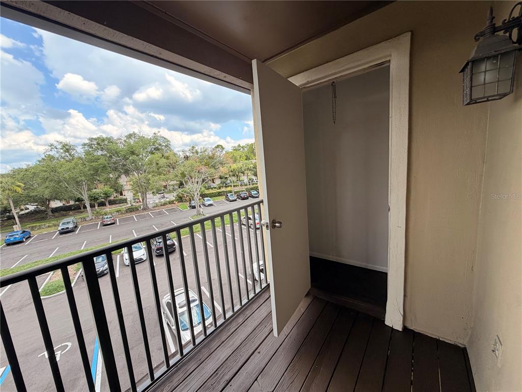A balcony with a metal railing overlooks a parking lot and features an exterior storage closet — 232 AFTON SQUARE UNIT 309, ALTAMONTE SPRINGS, FL