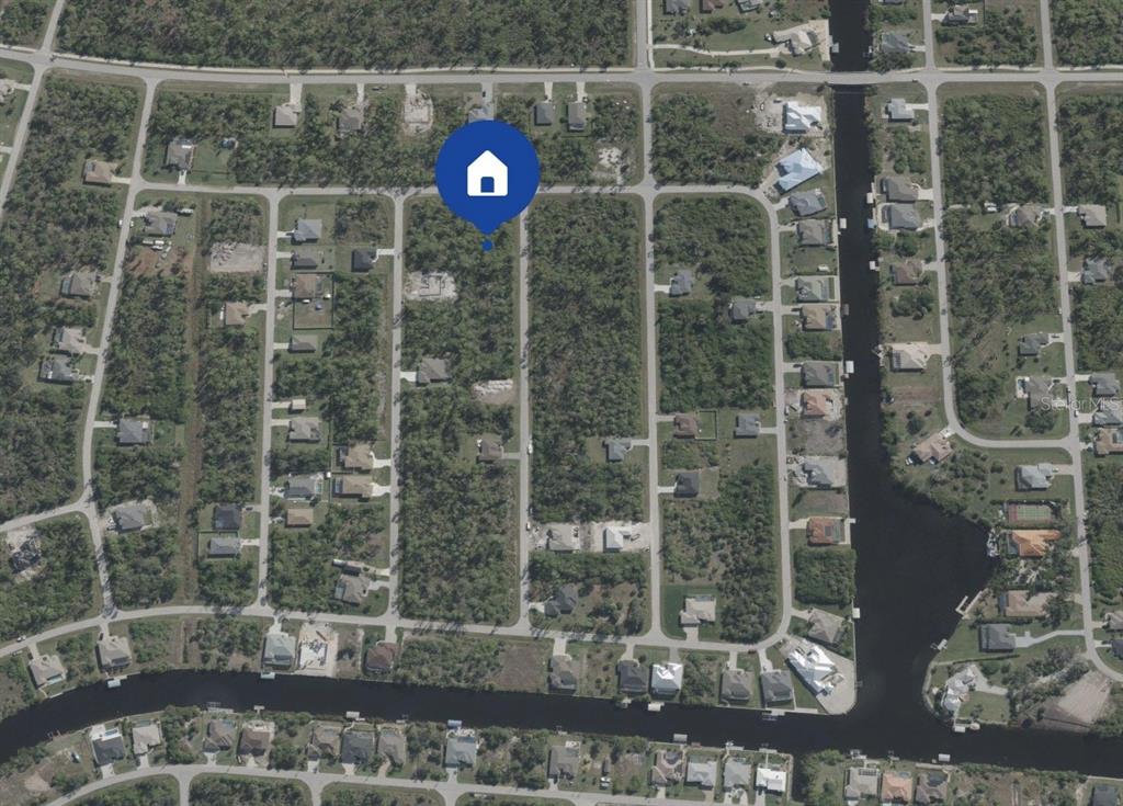 An aerial view shows a vacant residential lot marked with a house icon in Florida — 14340 SANILAC AVENUE, PORT CHARLOTTE, FL