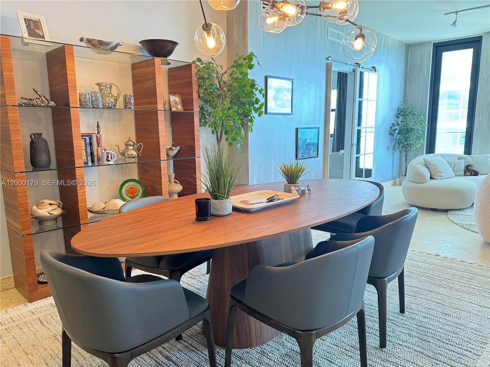 A dining room features an oval wooden table, gray chairs, and a glass display shelf — 10185 collins # 20, Bal Harbour FL 33154, BAL HARBOUR, FL