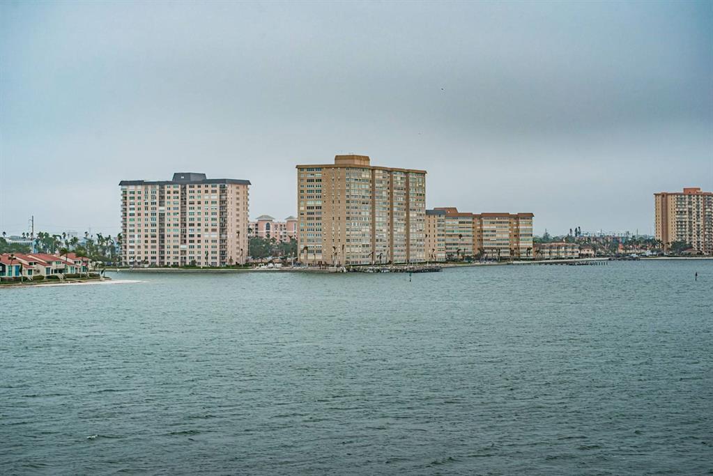 A view of several tall apartment buildings situated along a waterfront under a cloudy sky — 6218 PALMA DEL MAR BOULEVARD S UNIT 507, ST PETERSBURG, FL